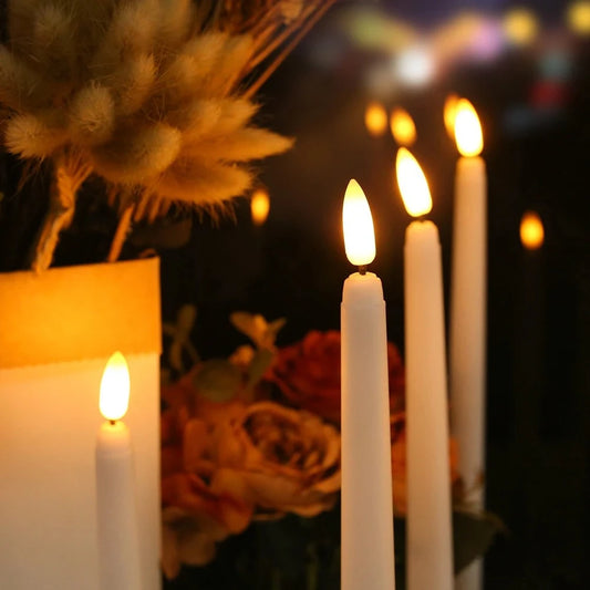 LED flameless taper candles flickering in candlesticks on a set dinner table