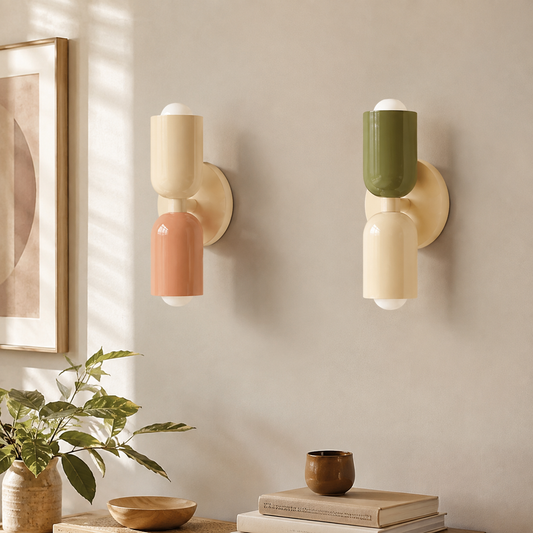 Macaron wall sconce with a soft colored globe mounted beside a bed
