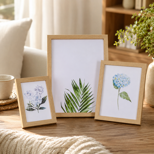 Wooden photo frame standing on a shelf beside books and a small plant