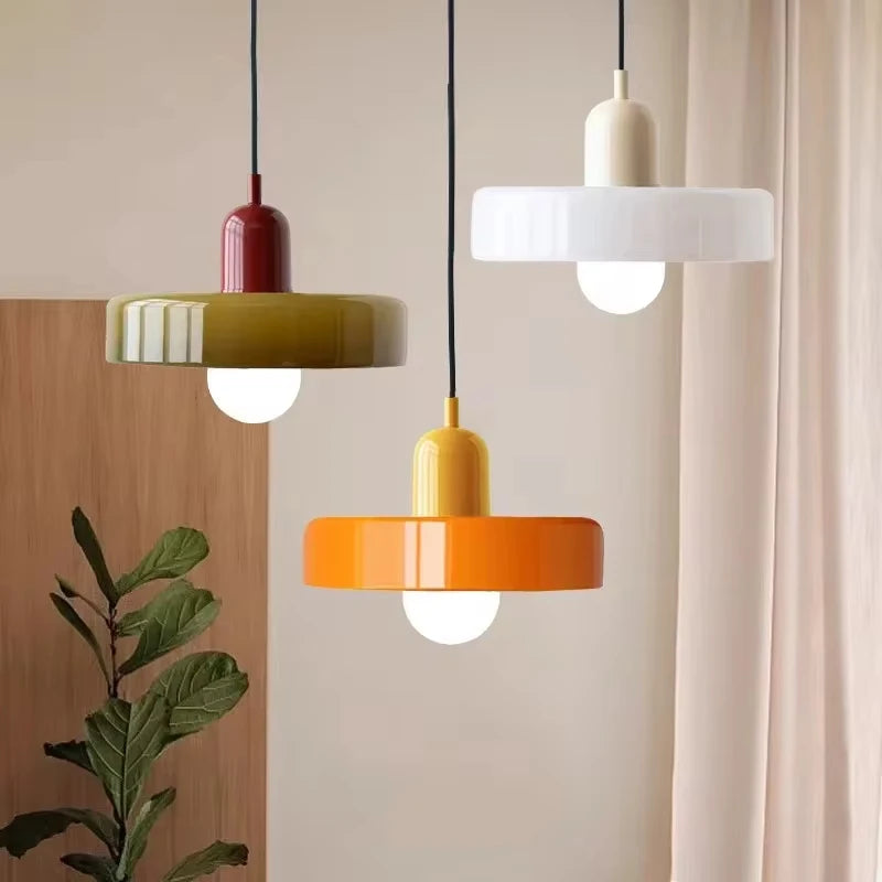 Bauhaus glass chandelier with clear globes hung low over a dining table