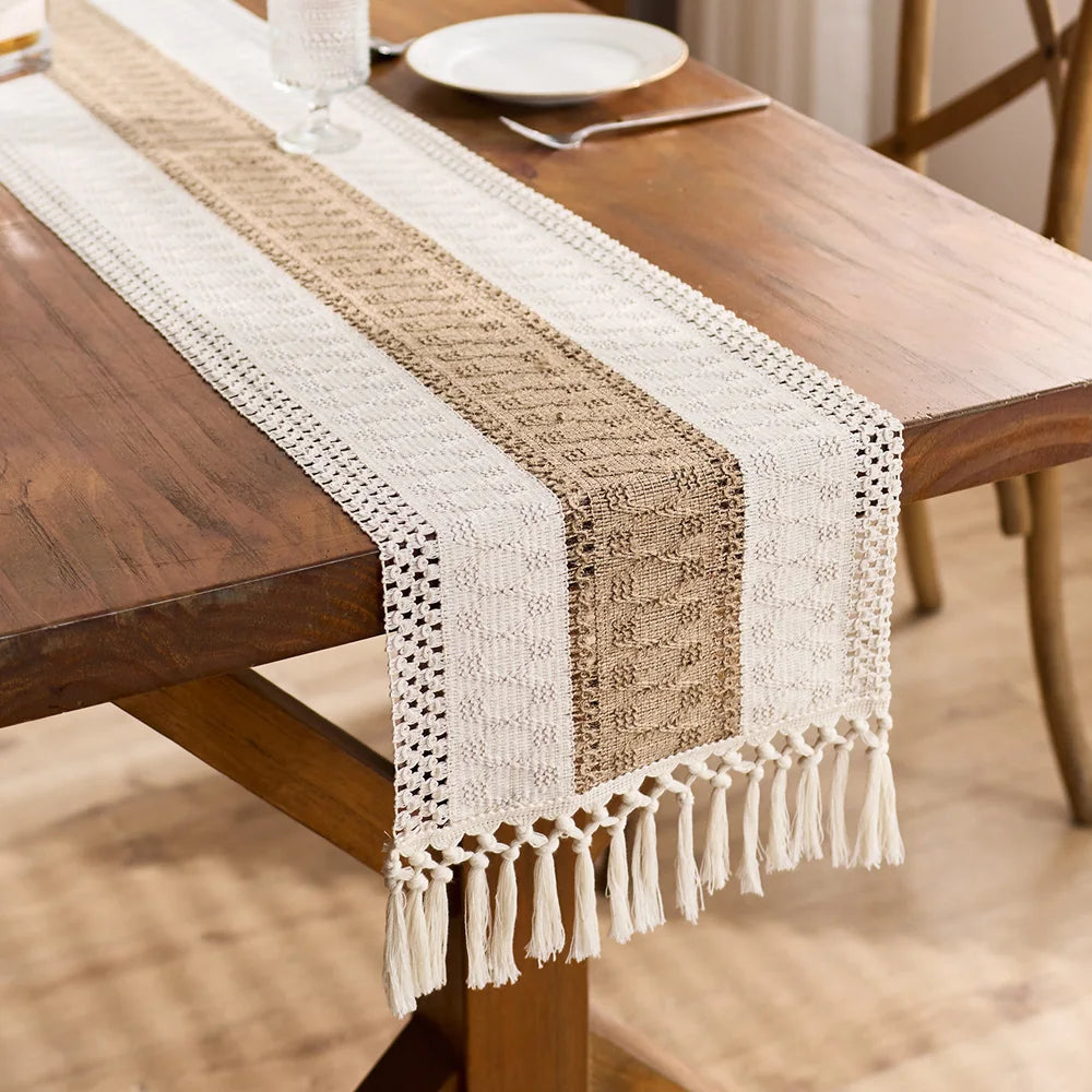 Macrame table runner with tassels down the center of a dining table
