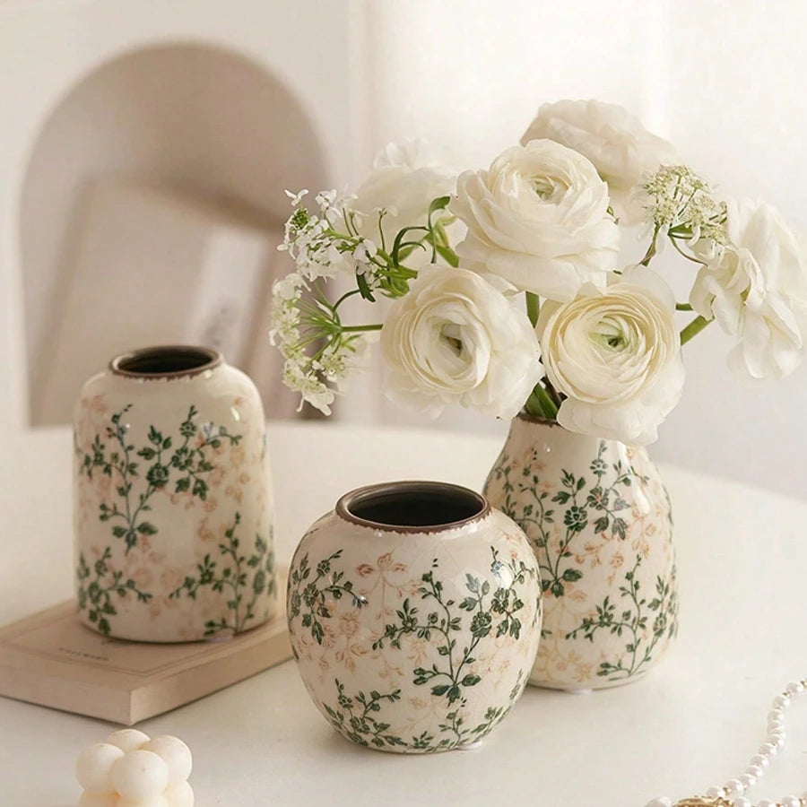 Crackle glaze ceramic vase on a shelf holding dried stems in afternoon light