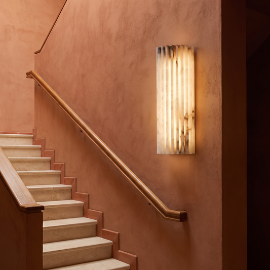 Natural stone marble wall lamp mounted along a staircase with soft glow