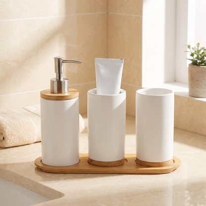 Coordinated ceramic bathroom set with soap dispenser, toothbrush holder, and tumbler on a counter
