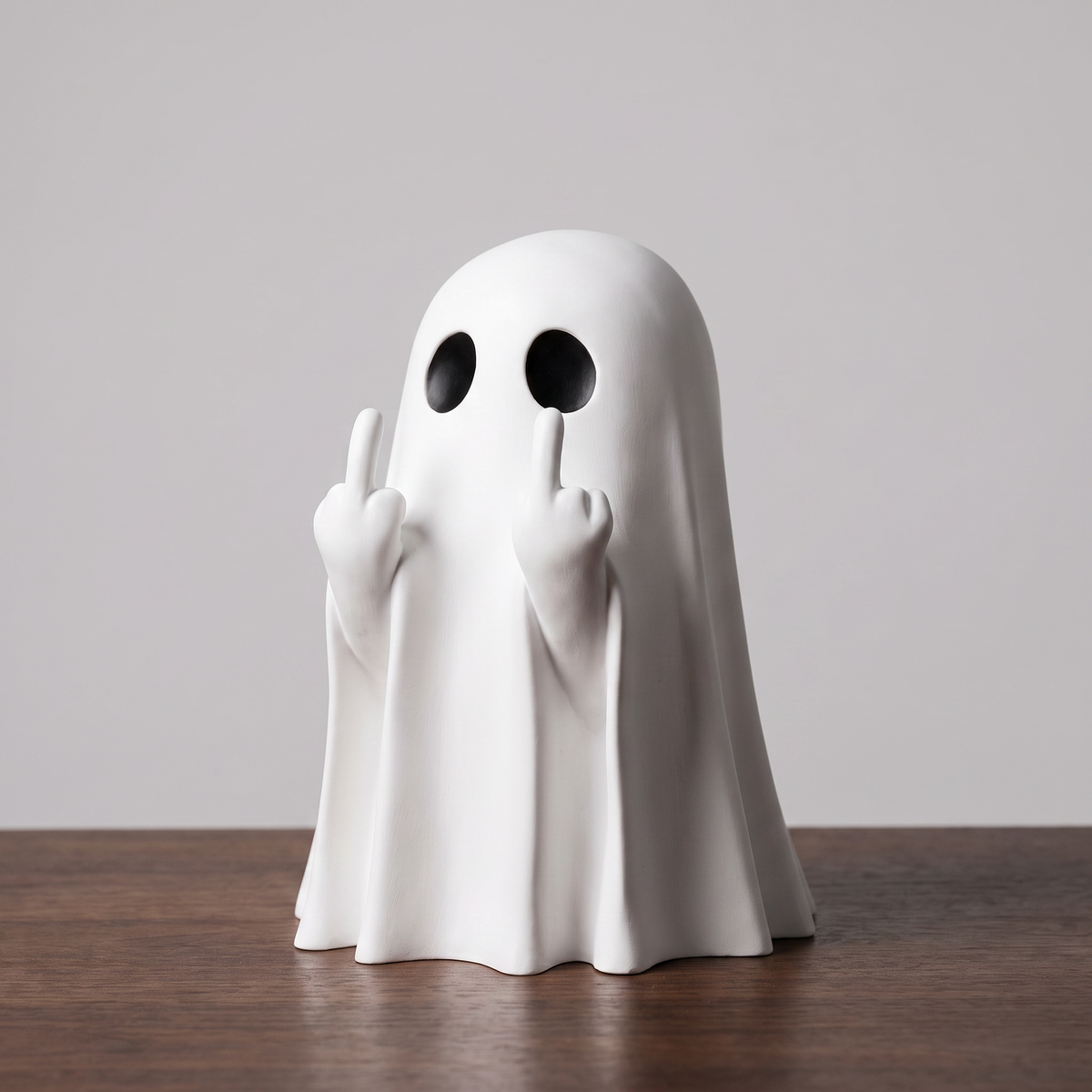Small novelty ghost statue decoration on a neutral background